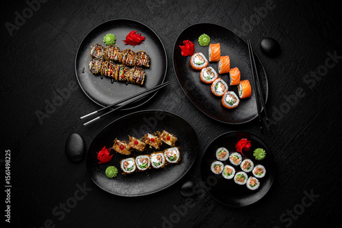 Sushi set composition on black background. The Art of Japanese Cuisine. Food photography for menu and sushi bar decoration