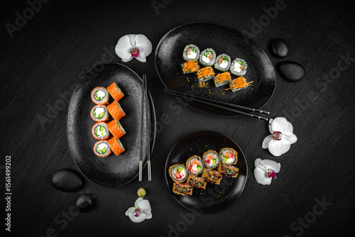 Sushi set composition on black background. The Art of Japanese Cuisine. Food photography for menu and sushi bar decoration