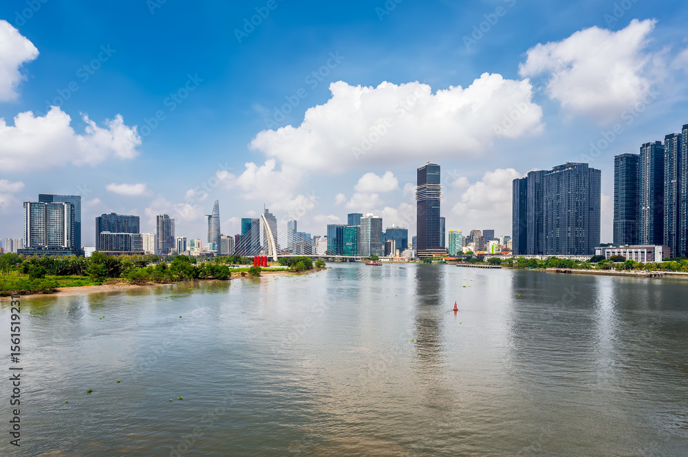 Obraz premium View of Ho Chi Minh City next to the Sai Gon River with modern high-rise buildings, Vietnam.