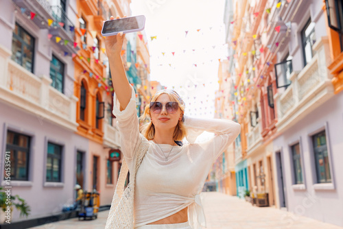Young caucasian female tourist enjoys colorful street in Hanoi's park Venice Vietnam