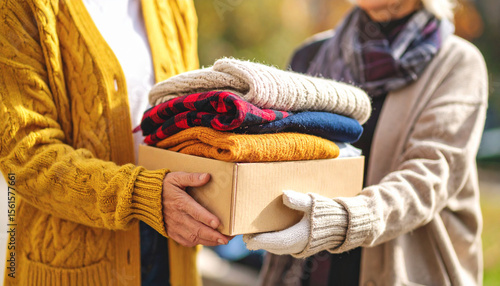 Help or hands with donation for homeless person, without visible face; concept of helping and care