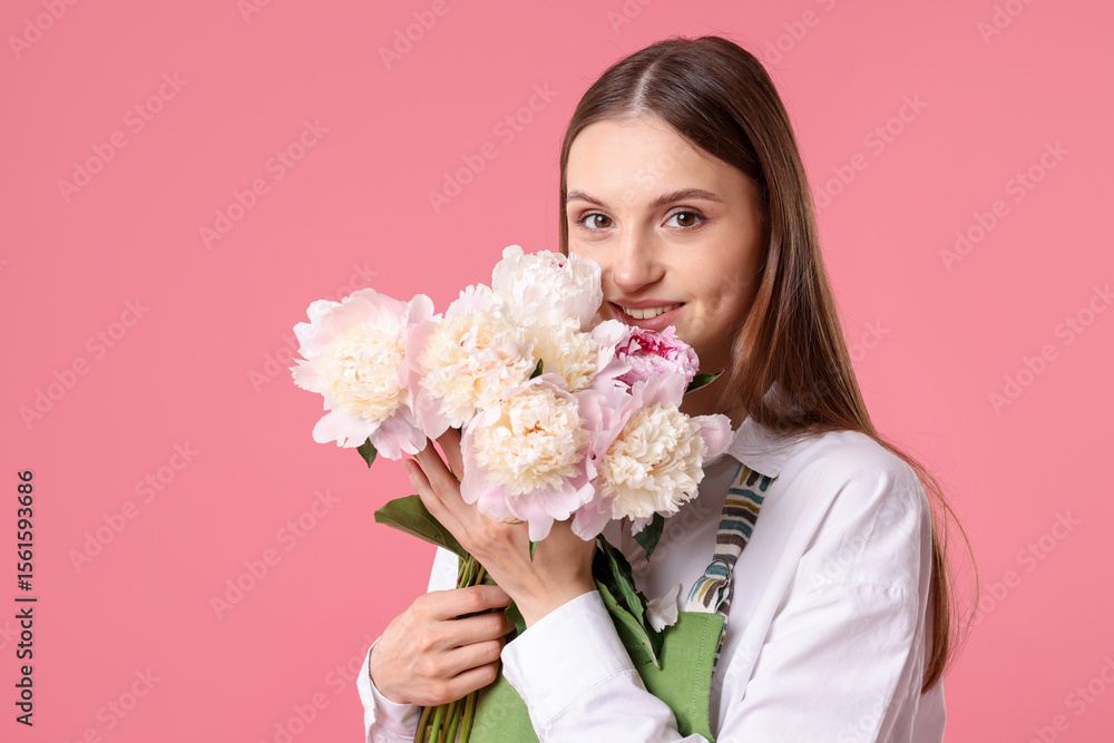 Florist with beautiful peonies on pink background Florist with beautiful peonies on pink background