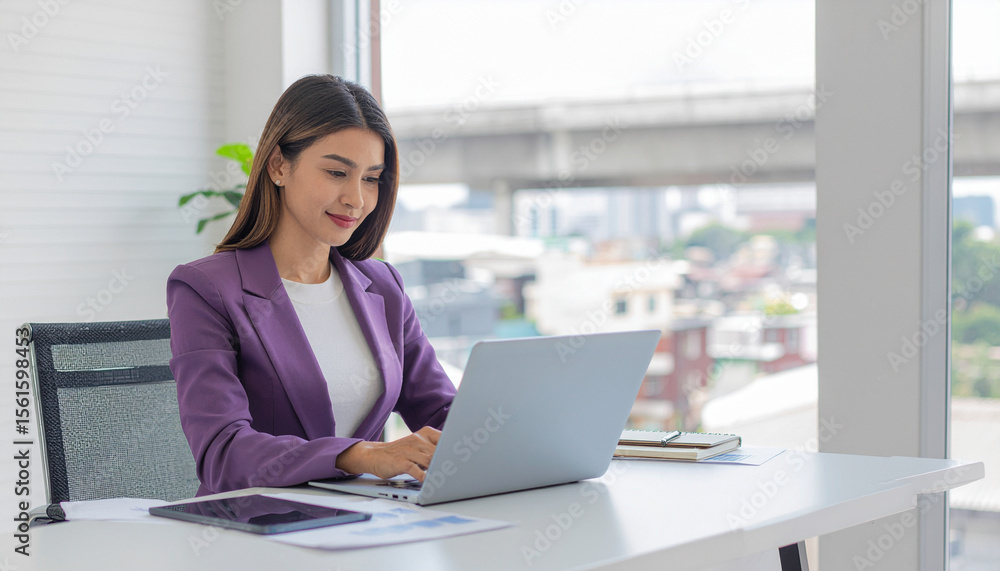 Smart Hispanic businesswoman using laptop by window view Smart Hispanic businesswoman using laptop by window view