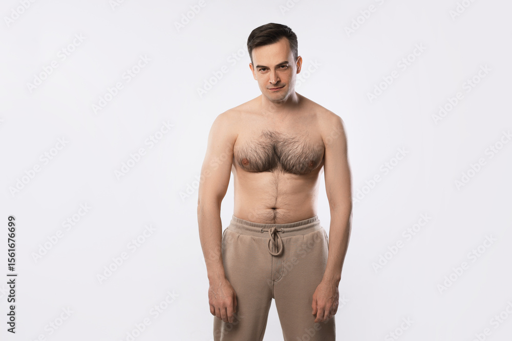 Fototapeta premium Man with incorrect posture posing on light grey background