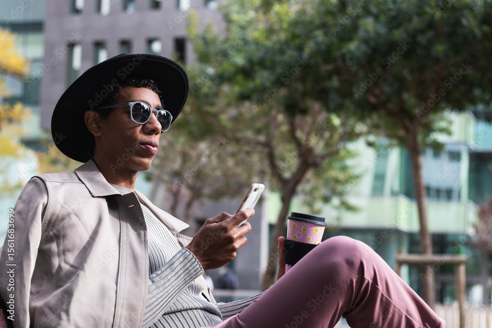 Stylish ethnic man with smartphone and coffee to go outdoors. Side view of adult ethnic male in trendy apparel and sunglasses chatting on cellphone while resting with takeaway hot drink in town Stylish ethnic man with smartphone and coffee to go outdoors. Side view of adult ethnic male in trendy apparel and sunglasses chatting on cellphone while resting with takeaway hot drink in town