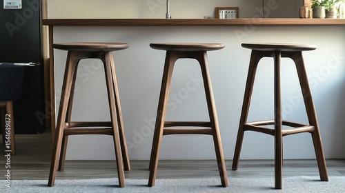 Wooden bar stool with round seat, suited for dining or kitchen areas