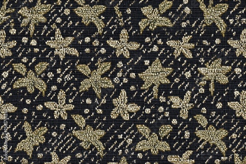 Dark fabric with a repeating pattern of light gold stylized flowers and leaves