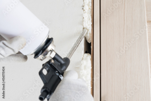 close-up of a gun for sealing and sealing a doorway, mounting foam