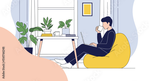 Young man enjoying a cup of coffee while working on his laptop in a cozy beanbag chair indoors