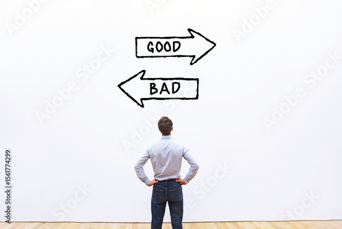 Photos good or bad choice, business ethics concept with direction arrows on white wall