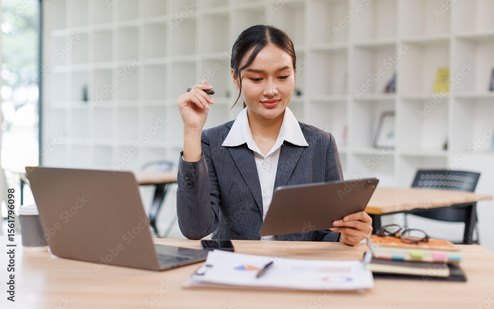 Business woman signs an electronic document on a digital document on a virtual tablet laptop computer screen,Paperless workplace idea, e-signing, electronic signature, document management. Business woman signs an electronic document on a digital document on a virtual tablet laptop computer screen,Paperless workplace idea, e-signing, electronic signature, document management.