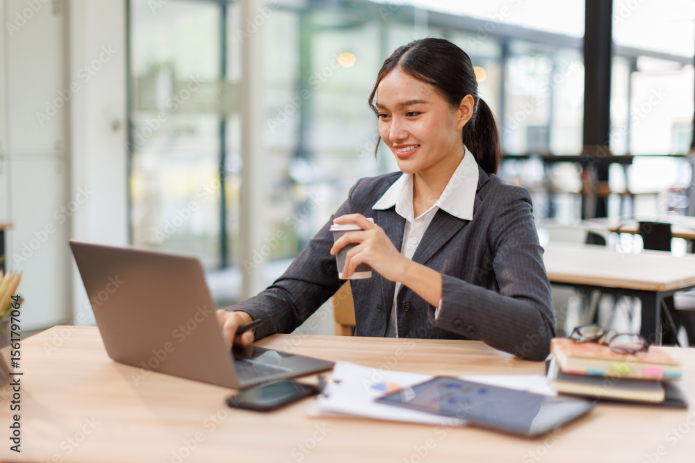 Fototapeta premium Asian business woman accounting holding coffee cup using calculating income-expenditure and analyzing real estate investment data report Financial and tax systems concept. 