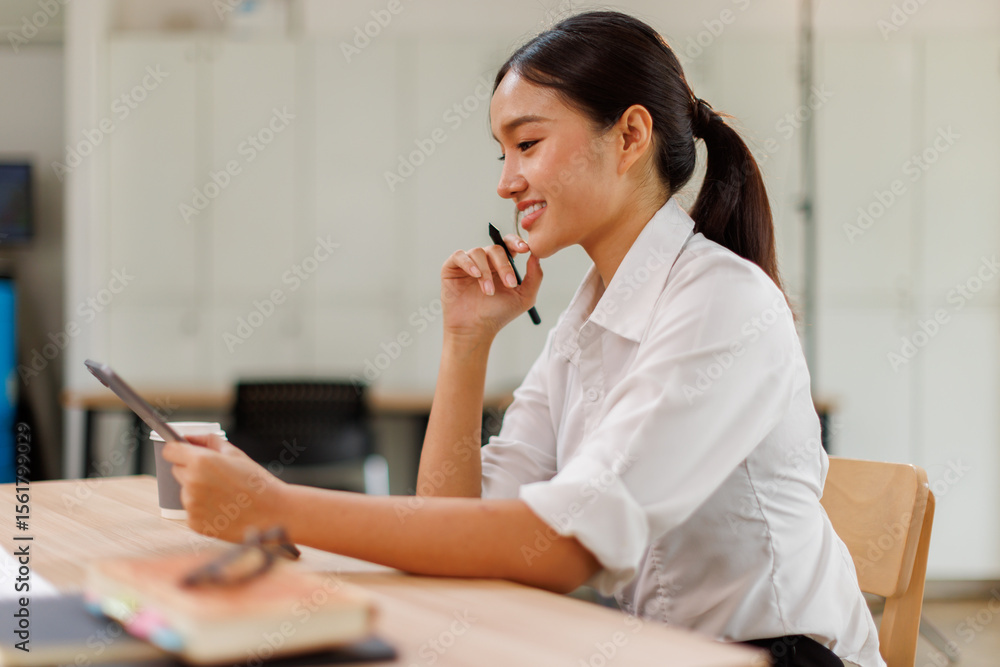 Young asian business woman manager accounting analyst checking bills, analyzing sales statistics management, taxes financial data documents or marketing report papers working in office using laptop. Young asian business woman manager accounting analyst checking bills, analyzing sales statistics management, taxes financial data documents or marketing report papers working in office using laptop.