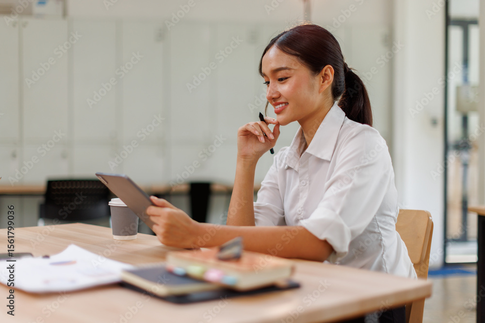 Young asian business woman manager accounting analyst checking bills, analyzing sales statistics management, taxes financial data documents or marketing report papers working in office using laptop. Young asian business woman manager accounting analyst checking bills, analyzing sales statistics management, taxes financial data documents or marketing report papers working in office using laptop.