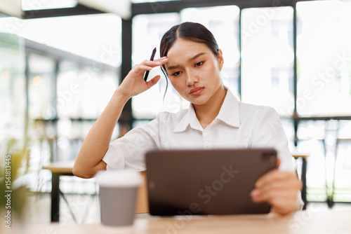 Young stressed caucasian businessasian woman working in the office. Businessman thinking too much work concept in the office.Tired, stressed headaches a long time Office syndrome concept.
