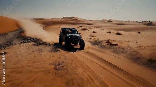 Dark SUV driving through desert sand dunes