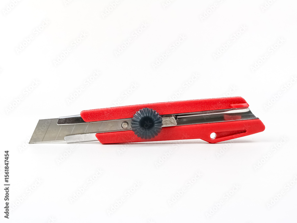 Red utility knife cutter isolated on white background. Stationery cutter knife Red utility knife cutter isolated on white background. Stationery cutter knife