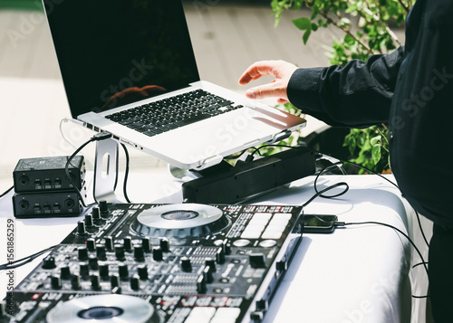 Obraz na plátně Professional DJ setup with laptop and audio mixer controller prepared for an outdoor event