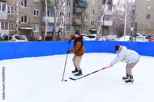 Photography People skate and play ice hockey in the yard
