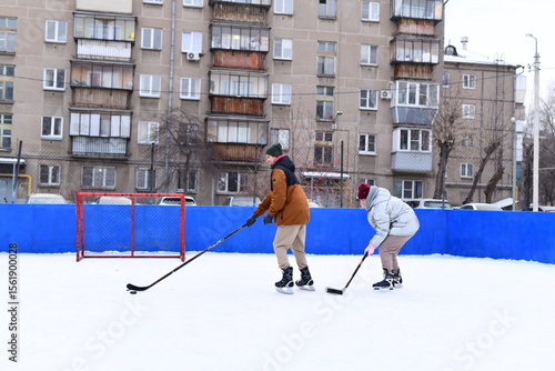 Photography People skate and play ice hockey in the yard