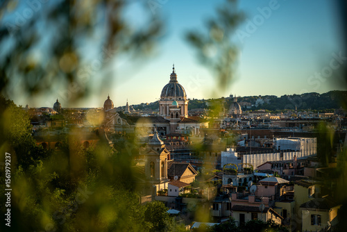 Golden hour sunset with beautiful warm cityscape of Rome, Italy.