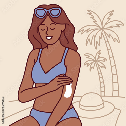Dark skinned woman in swimsuit applies SPF cream to shoulder on sunny beach. She uses sunscreen to protect skin from sun damage while on vacation