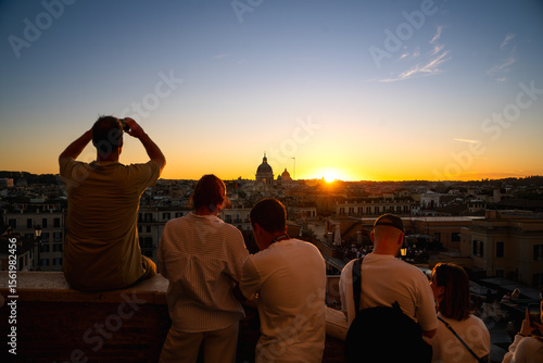 people at sunset looking at cityscape of Rome city