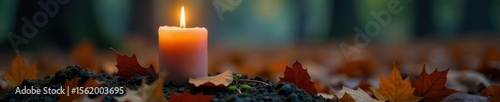 Glowing grave candle beside fallen autumn leaf , remembrance, decay