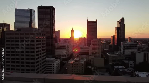 City skyline at sunrise with satellite dish on rooftop