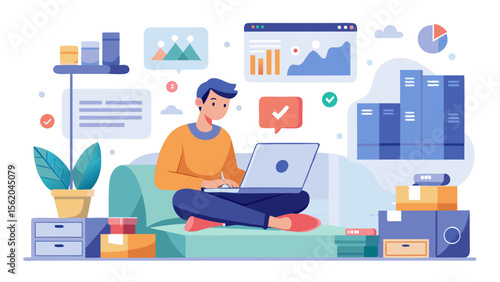 A man is sitting on a couch and working on his laptop. The room is cluttered with boxes and a potted plant. The man is focused on his work, and the room has a casual, relaxed atmosphere