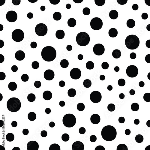 Seamless pattern of scattered black circles on a white background texture
