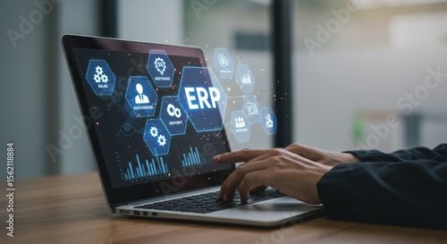 Person using laptop with ERP software interface