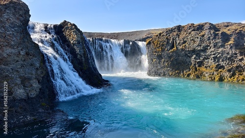 Waterfall on the blue river in Iceland