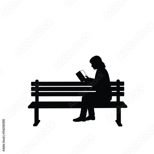 Silhouette of a man sitting on a bench with a book