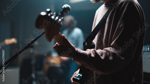 The guitarist plays passionately during a live band rehearsal in the studio.