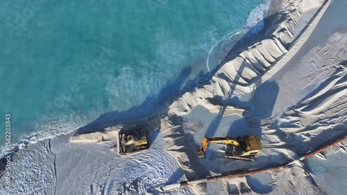 Aerial view of construction vehicles by the sea, Maldives.