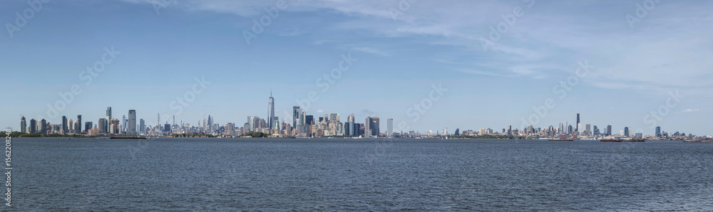 Obraz premium super wide angle view of new york city skyline on the hudson river with jersey city and brooklyn skyscrapers and statue harbor scene travel tourism destination manhattan nyc jc nj ny liberty state
