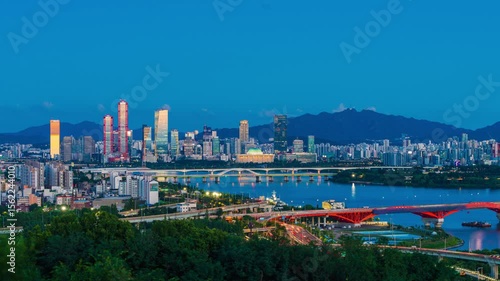 Wallpaper Mural Zoom in,Timelapse,  Mapo-gu, Seoul, South Korea - July 29, 2025: Day and night view of Yanghwa Bridge on Han River against National Assembly and skyscrapers of financial district 
 Torontodigital.ca