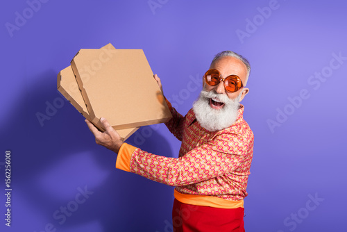 Slika na platnu Stylish elderly man in a retro shirt with pizza boxes exudes charisma, showcasin