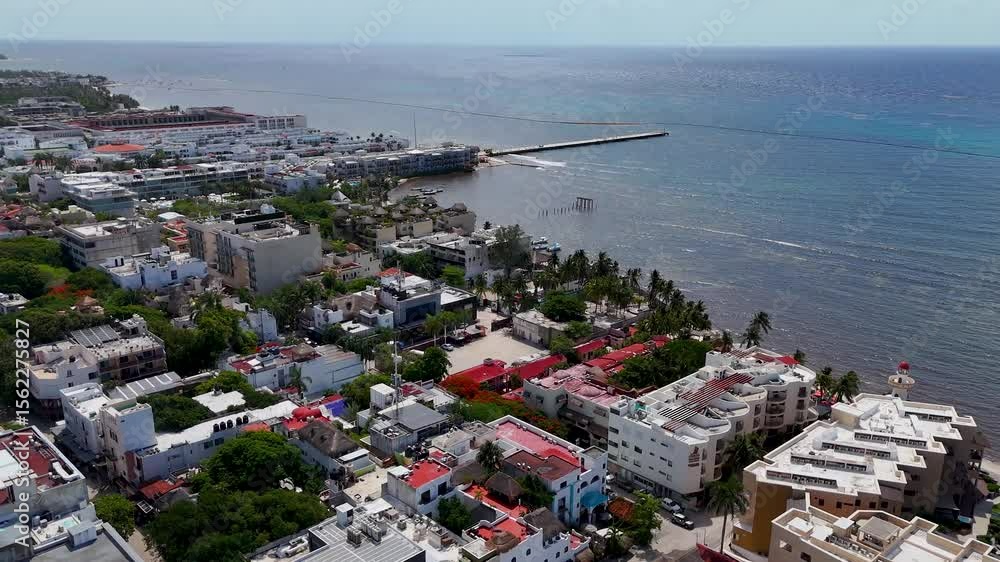 Aerial drone landscape view of playa del carmen downtown area with blue Caribbean Sea and blue sky on a sunny morning