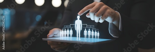 Businessman holding tablet with holographic figures, symbolizing digital recruitment, virtual workforce, and future-ready HR technology