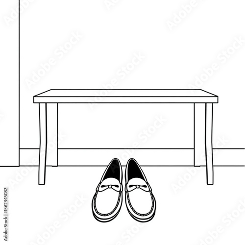 A pair of loafers under a hall bench