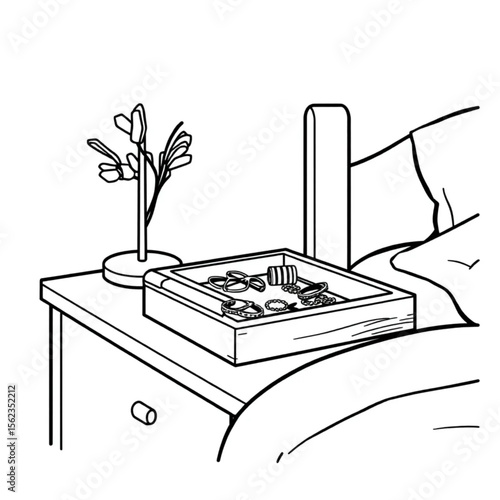 A wooden jewellery tray on a bedside table