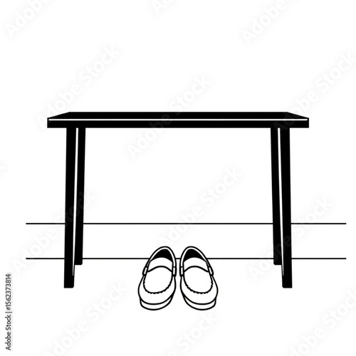 A pair of loafers under a hall bench