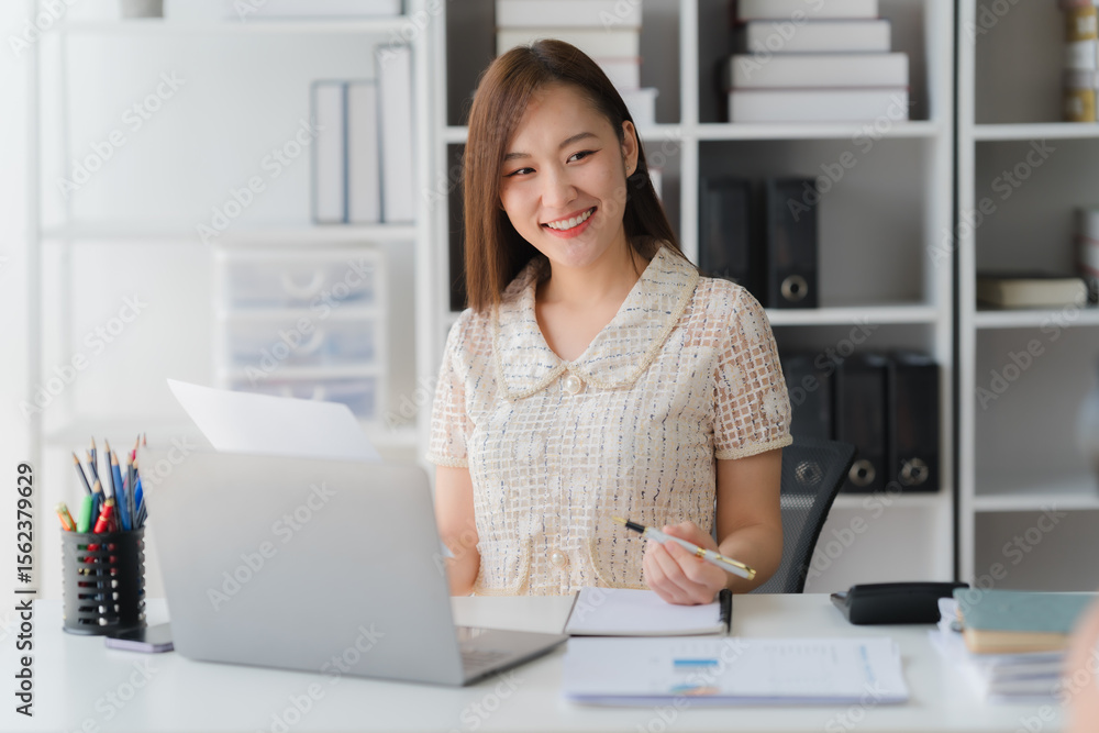 Smart Professional in Office: A poised professional sits at a well-organized desk, working diligently with a laptop and papers in a bright, tidy office setting. Capturing the essence of focus. Smart Professional in Office: A poised professional sits at a well-organized desk, working diligently with a laptop and papers in a bright, tidy office setting. Capturing the essence of focus.