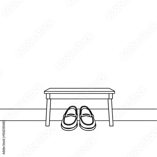 A pair of loafers under a hall bench