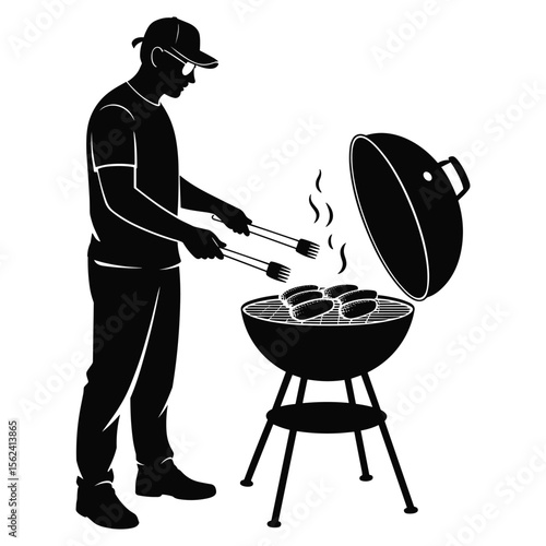 Man grilling sausages on a barbecue grill in silhouette