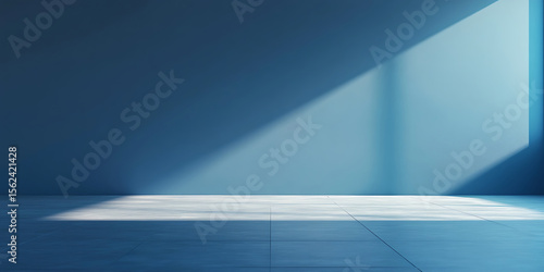 Modern interior with concrete floor and blue wall bathed in natural light creating minimalist and serene atmosphere ideal for background