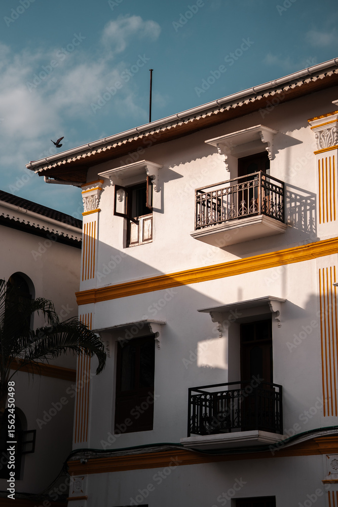 custom made wallpaper toronto digitalHotel facade with windows and balcony in Stone Town, Zanzibar