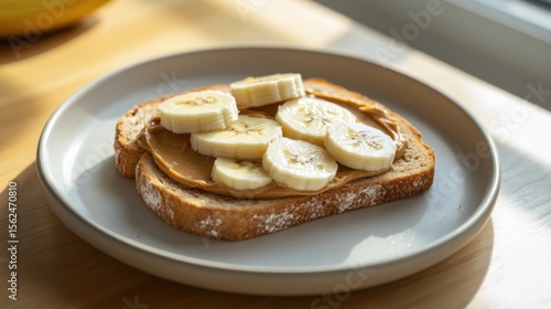 toast bread with peanut butter and banana light background